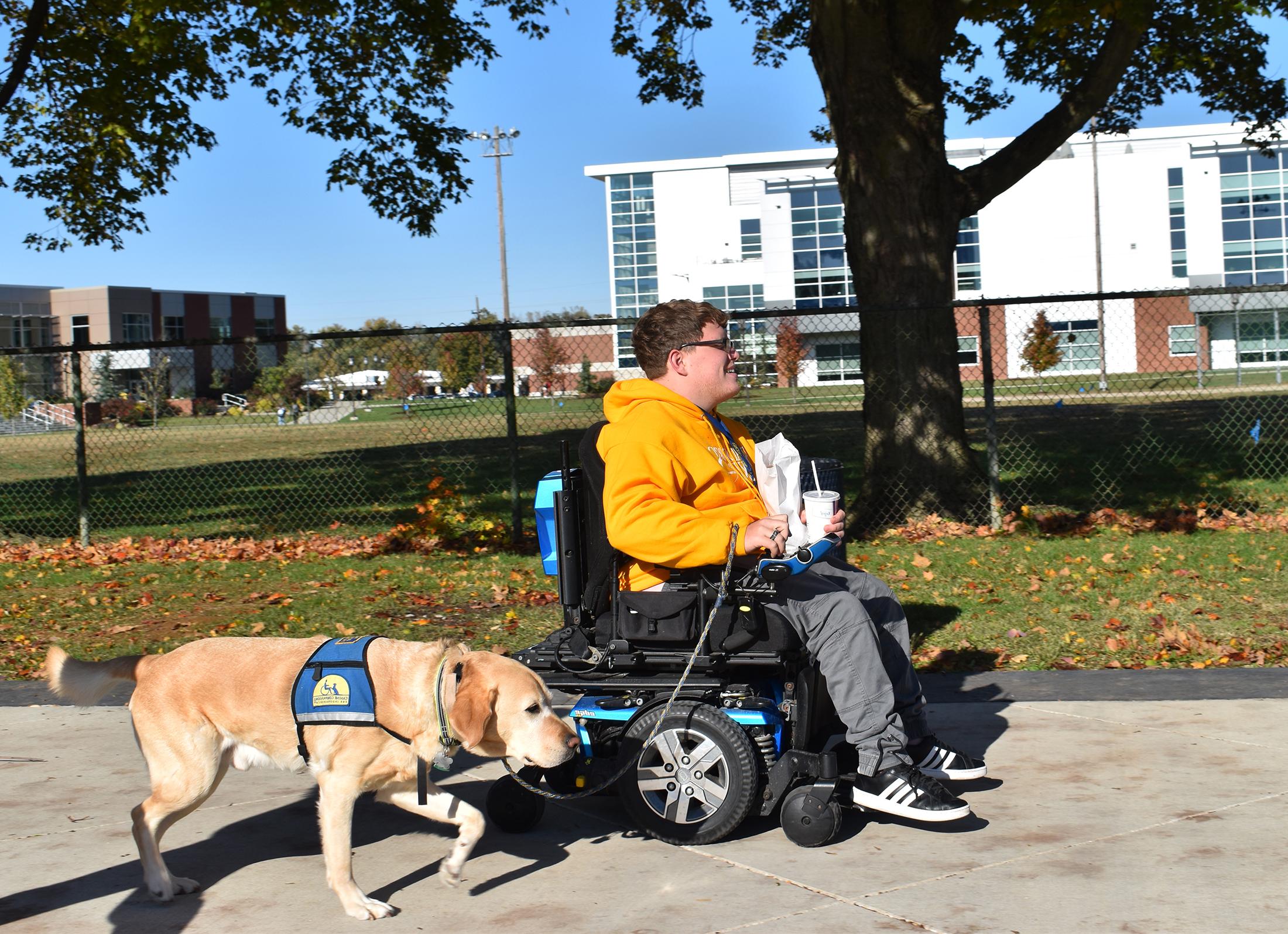 A student and his service dog out for a walk